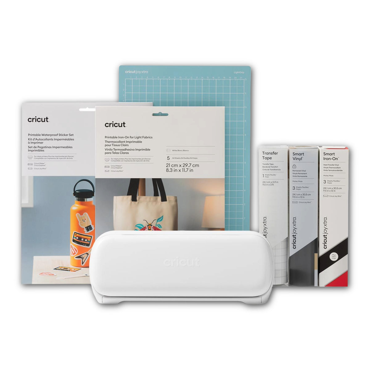 A Cricut crafting bundle featuring a white cutting machine in the foreground, surrounded by various accessories including a blue cutting mat, water bottle sticker set, transfer vinyl, smart vinyl, and a tote bag sticker, all on a clean white background.